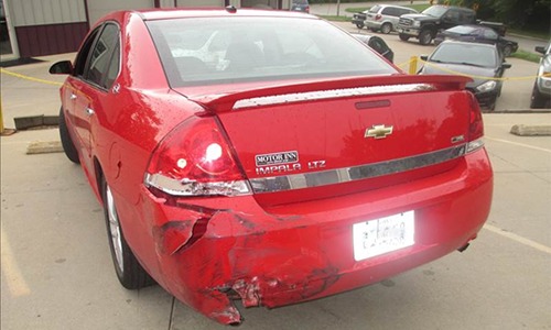 red Impala damaged rear bumper before